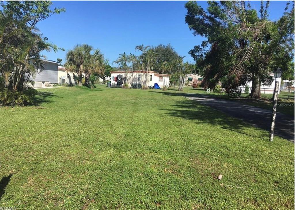 171 Pine Key Lane, Unit 28 Naples, FL 34114 - Photo 2 of 8 a view of yard with tree s
