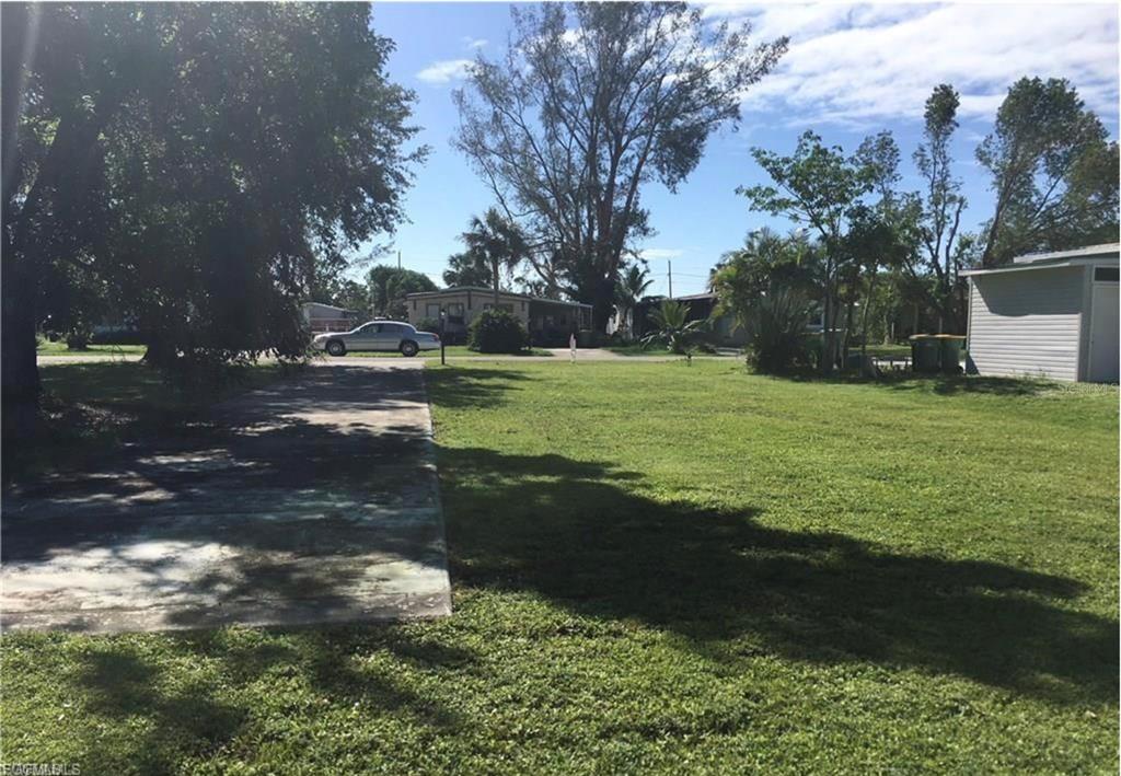 171 Pine Key Lane, Unit 28 Naples, FL 34114 - Photo 3 of 8 a view of a yard with an outdoor space
