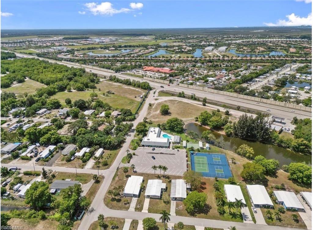 171 Pine Key Lane, Unit 28 Naples, FL 34114 - Photo 4 of 8 an aerial view of residential houses with outdoor space and trees