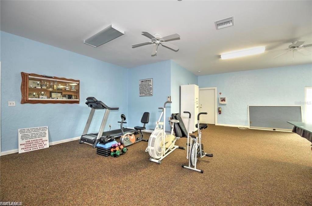 171 Pine Key Lane, Unit 28 Naples, FL 34114 - Photo 6 of 8 a view of a room with gym equipment