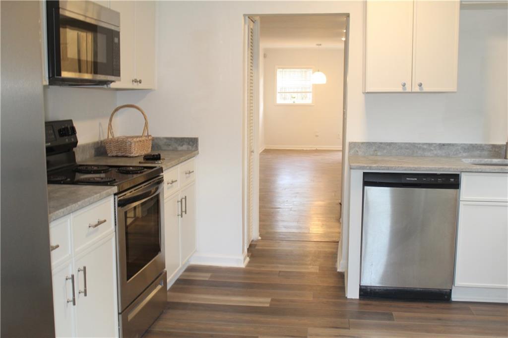 1076 Grant Way Southeast Atlanta, GA 30315 - Photo 8 of 29 a kitchen with granite countertop white cabinets and stainless steel appliances
