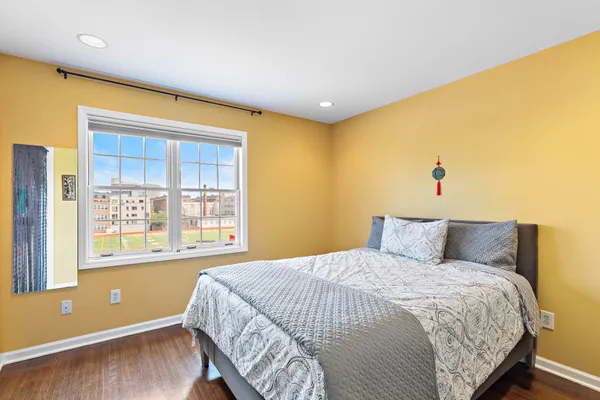 a bedroom with a large bed and a window