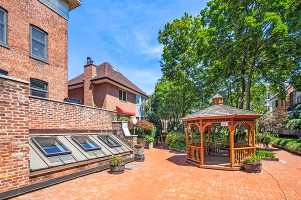 a view of a house with a yard and furniture