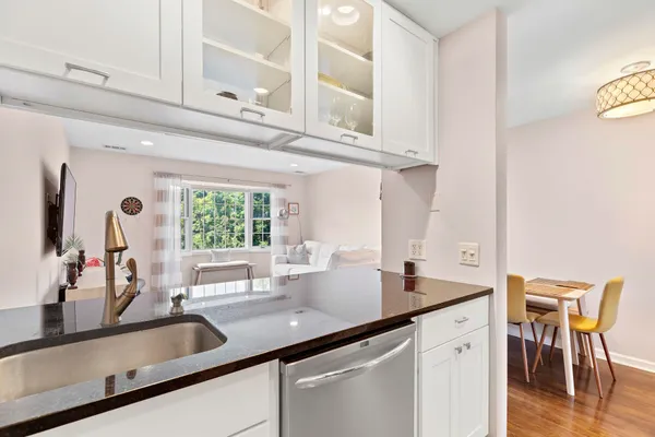 a kitchen with stainless steel appliances granite countertop a sink and a cabinets