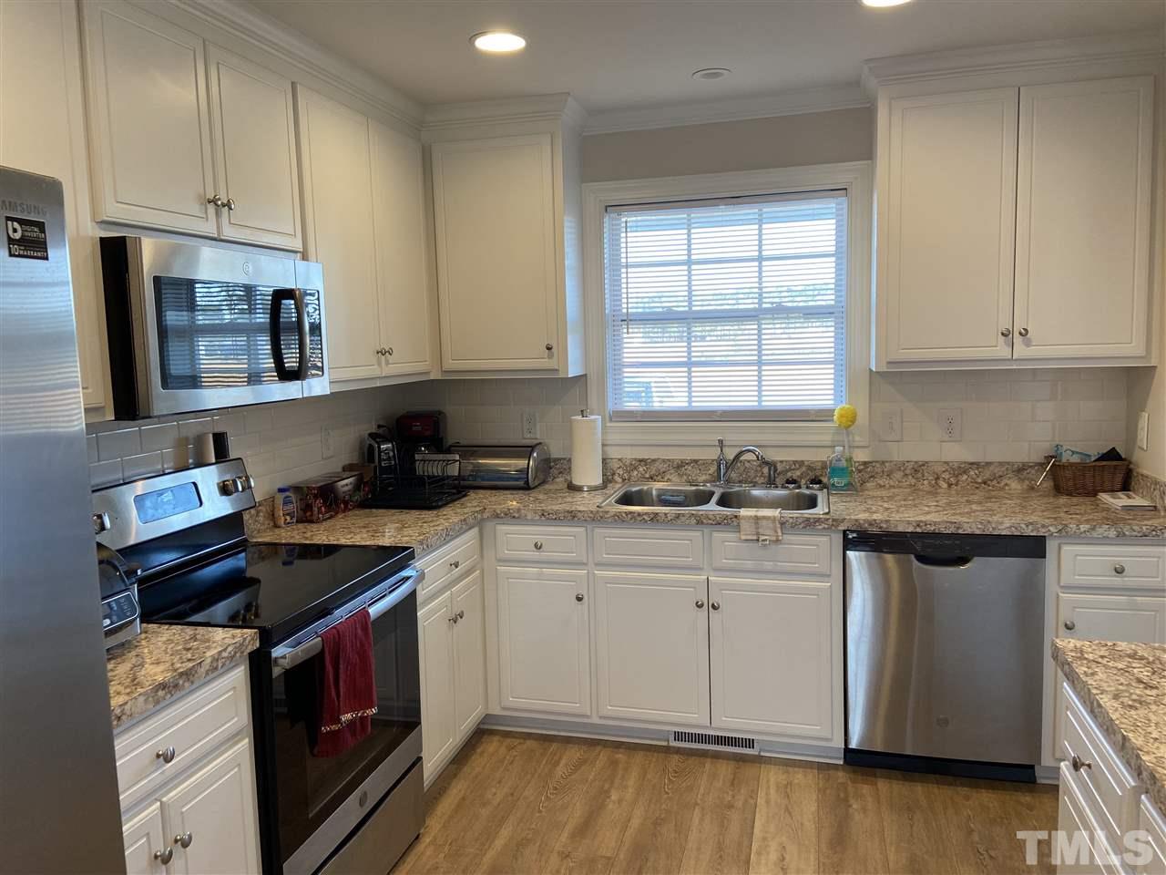 5289 Needham Road Bailey, NC 27807 - Photo 3 of 10 a kitchen with granite countertop a sink a stove and cabinets