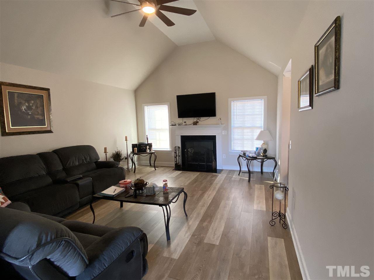 5289 Needham Road Bailey, NC 27807 - Photo 5 of 10 a living room with furniture a fireplace and a flat screen tv