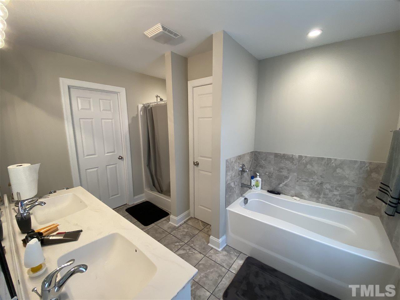 5289 Needham Road Bailey, NC 27807 - Photo 7 of 10 a bathroom with a tub sink and a mirror