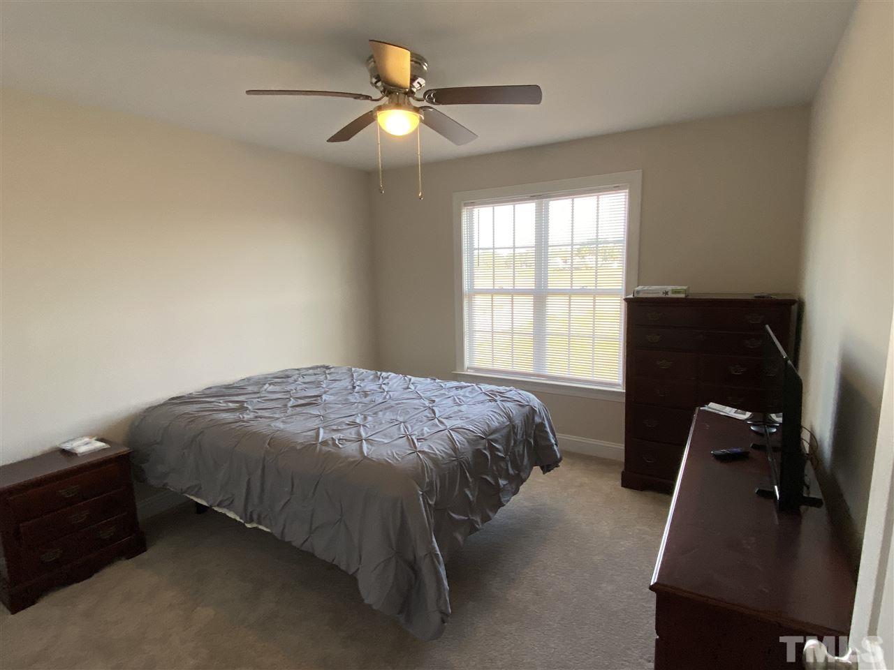 5289 Needham Road Bailey, NC 27807 - Photo 8 of 10 a bed sitting in a bedroom next to a window