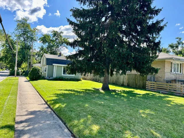 a swimming pool with outdoor seating and yard