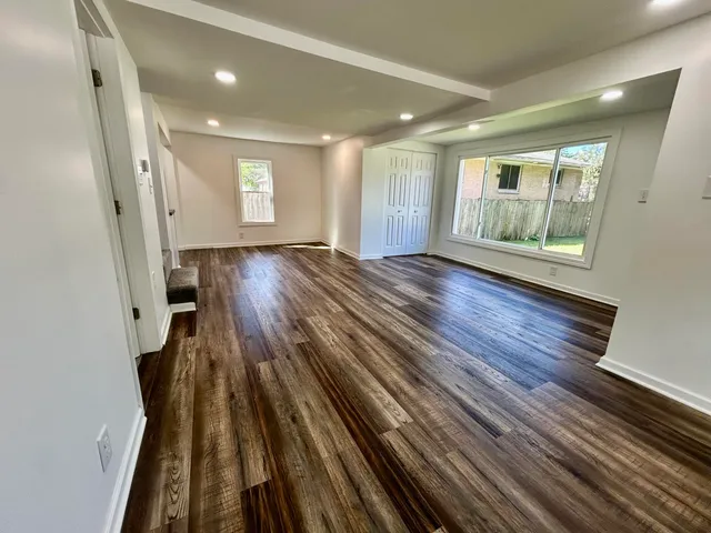 wooden floor in an empty room with a window