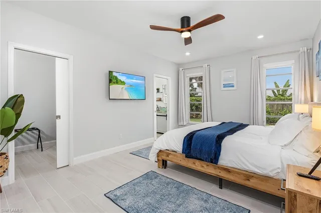 a bedroom with a bed a desk and chair