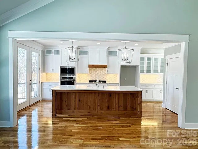 a kitchen with a refrigerator a sink and cabinets