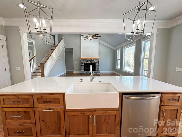 a view of a hallway with wooden floor and chandelier