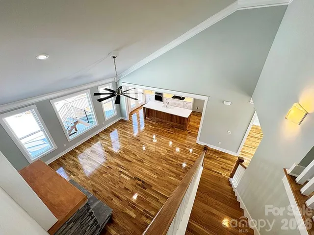 a spacious bathroom with a granite countertop sink a toilet and a mirror