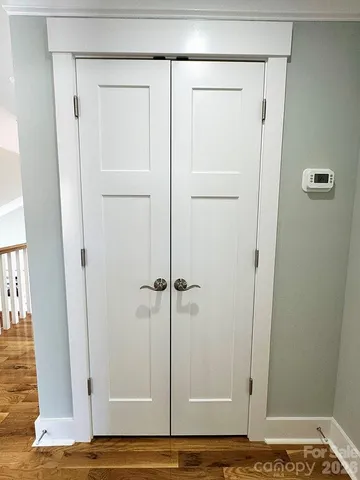 a view of a livingroom with wooden floor and a ceiling fan