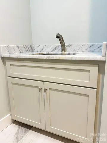 a view of an empty room and wooden floor and a window