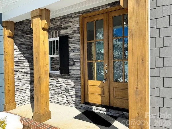 a view of a door and brick wall