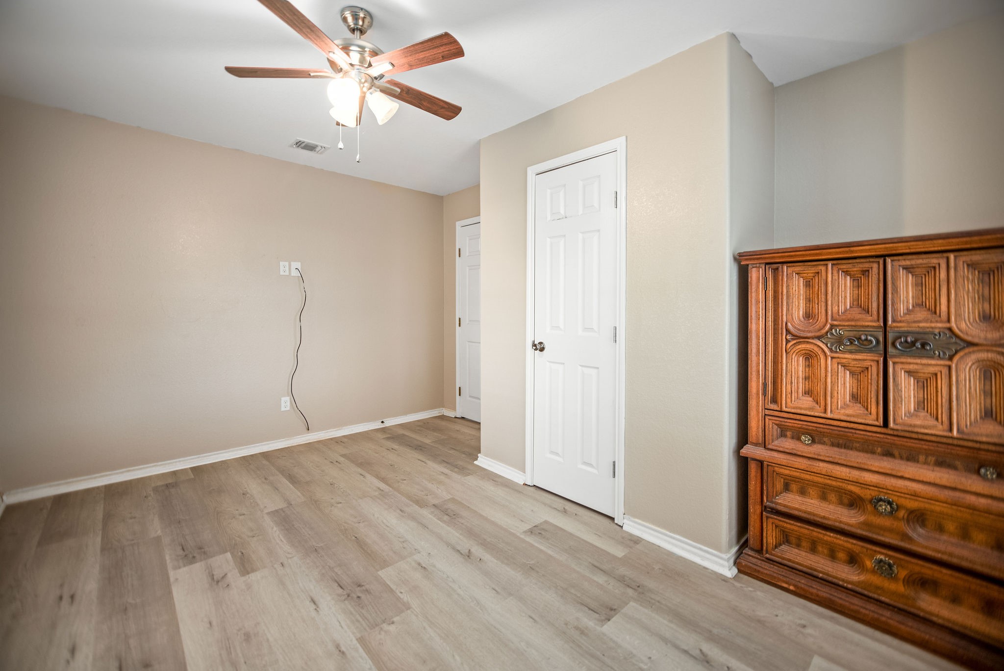 190 Hood Road Inez, TX 77968 - Photo 11 of 29 an empty room with wooden floor fan and windows