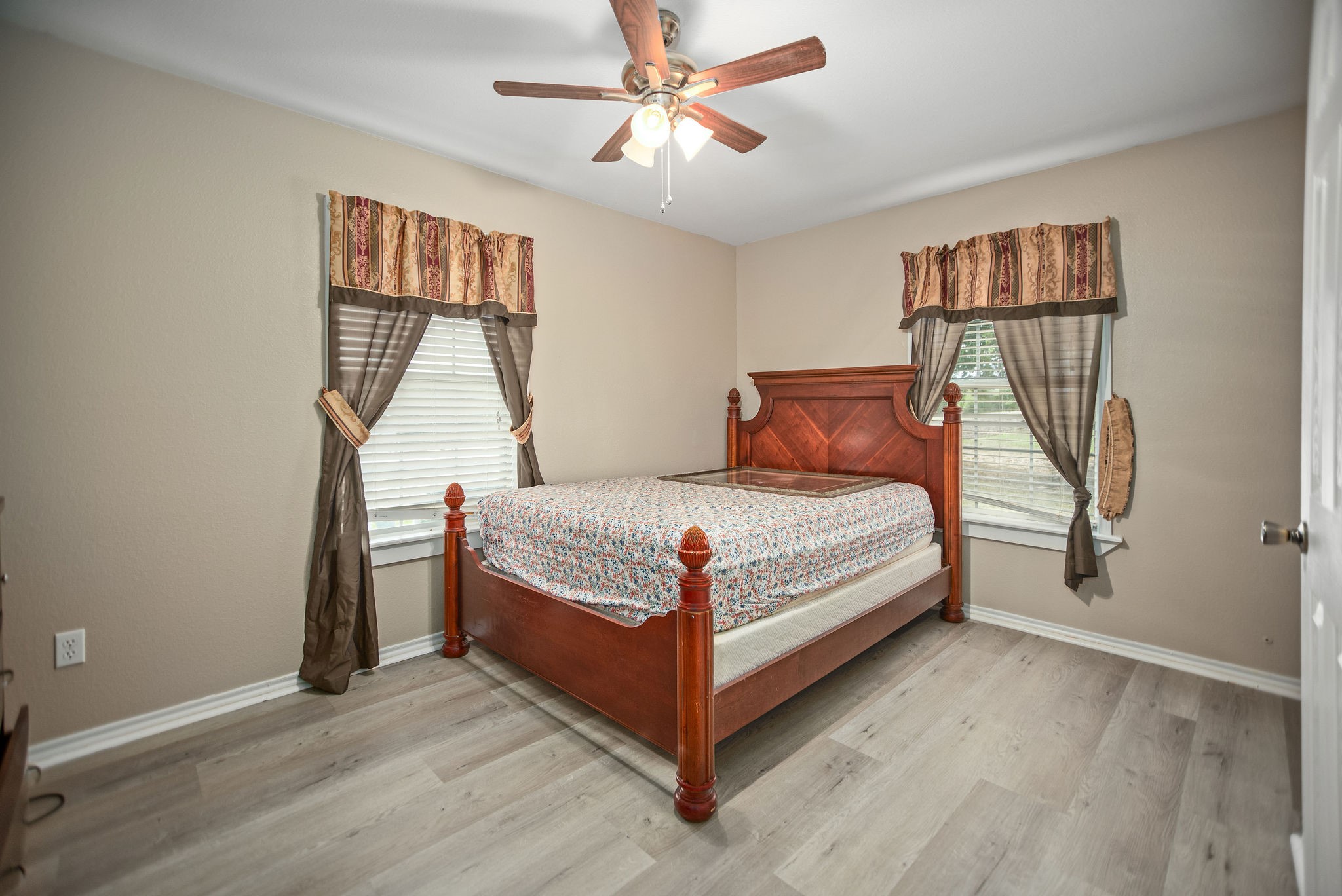 190 Hood Road Inez, TX 77968 - Photo 9 of 29 a bedroom with a bed and a chandelier