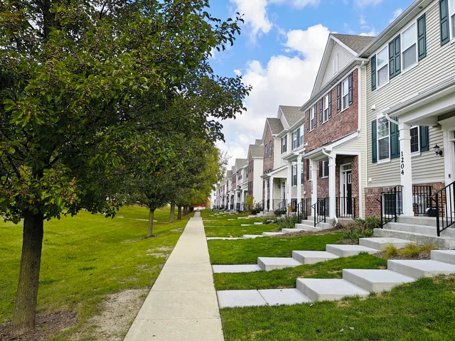 a front view of a house with a yard table and chairs