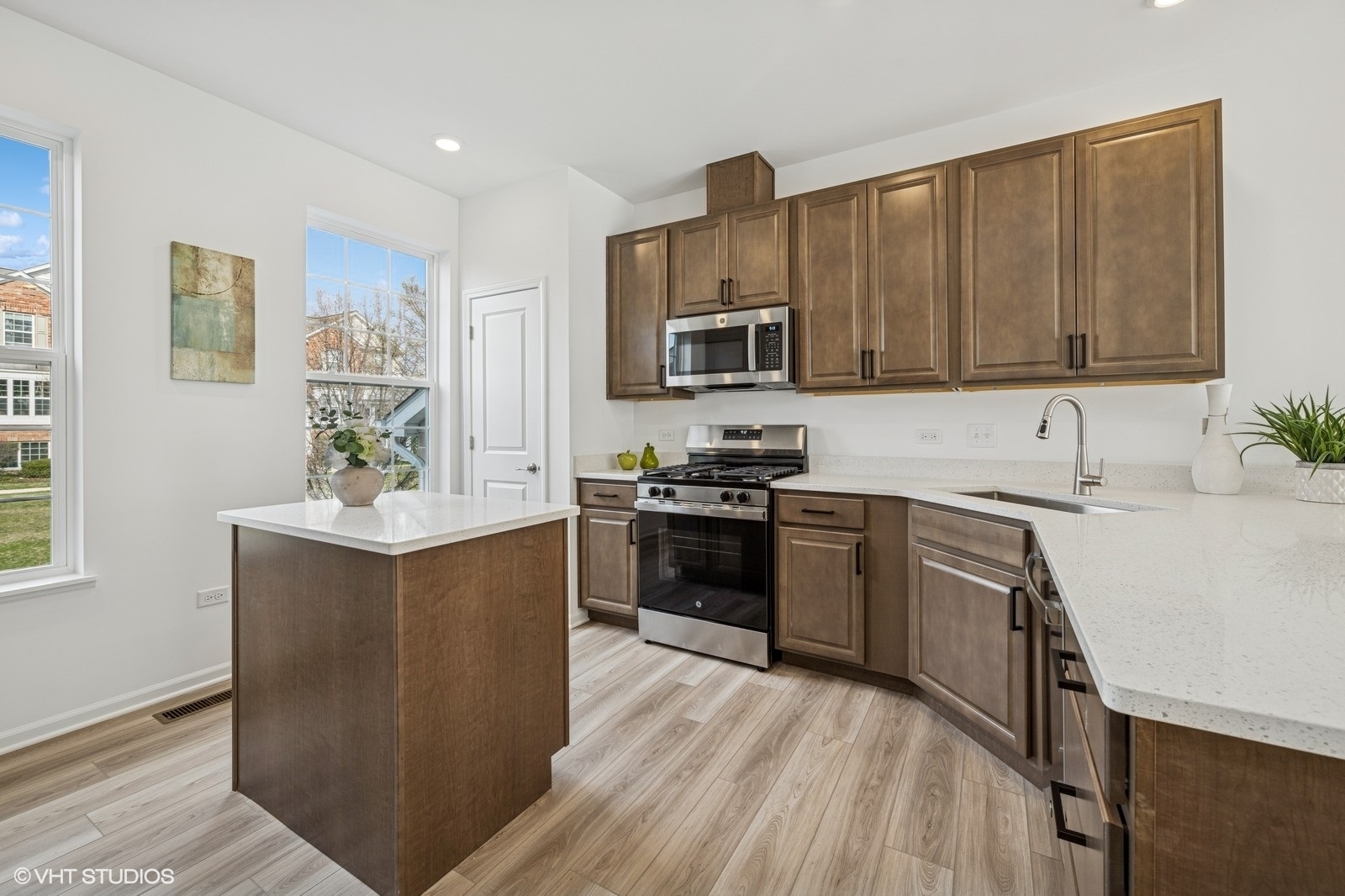 1204 Neubauer Circle, Unit 1304 Lindenhurst, IL 60046 - Photo 7 of 29 a kitchen with a sink cabinets and stainless steel appliances