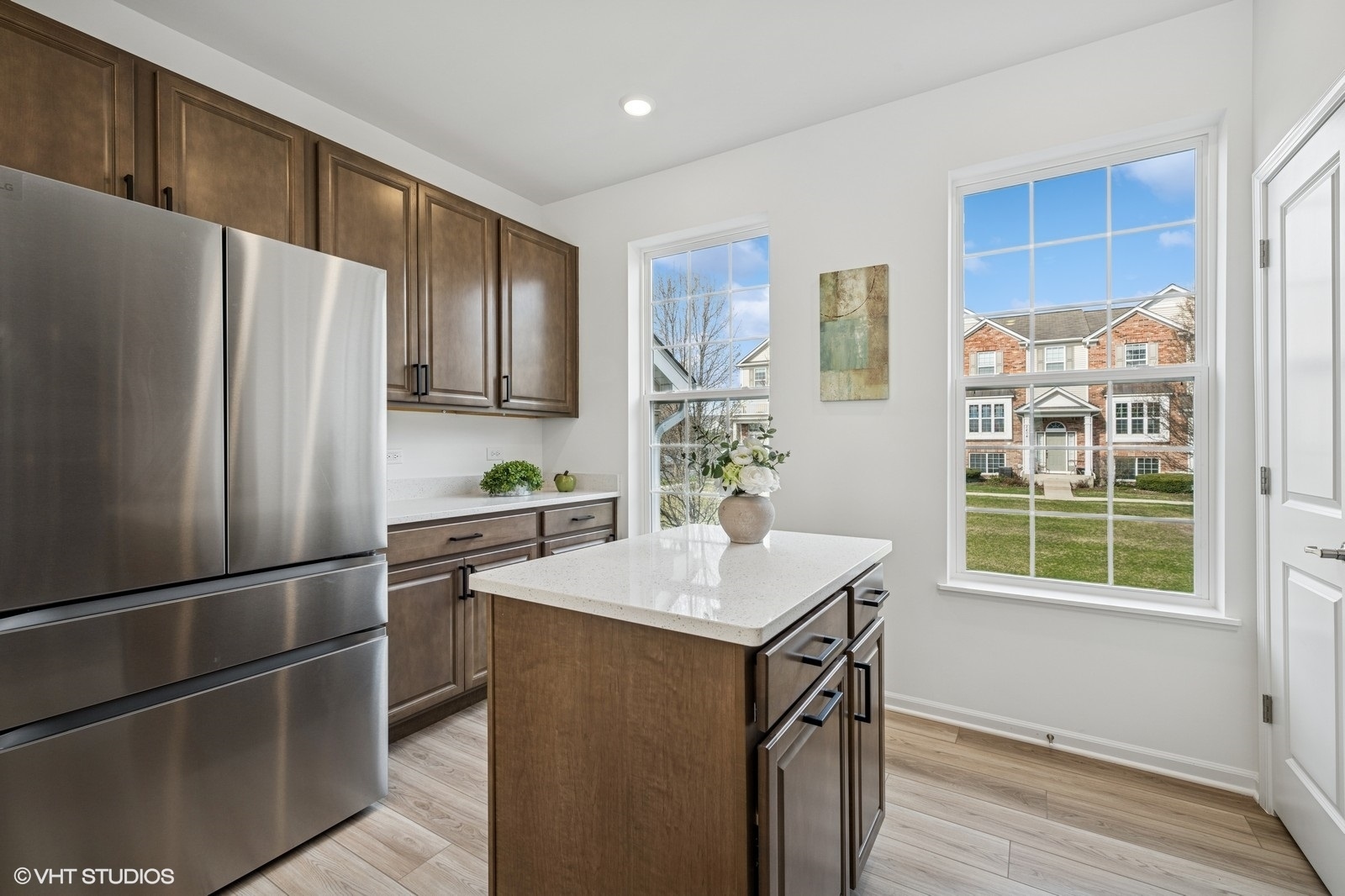 1204 Neubauer Circle, Unit 1304 Lindenhurst, IL 60046 - Photo 9 of 29 a kitchen with stainless steel appliances a refrigerator sink and wooden cabinets