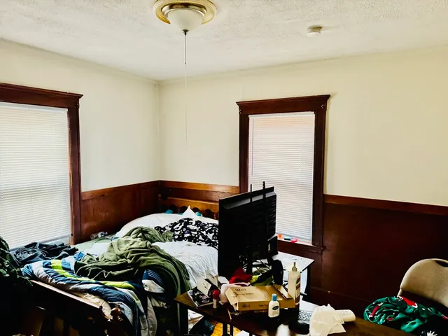 a bedroom with a bed and a dresser