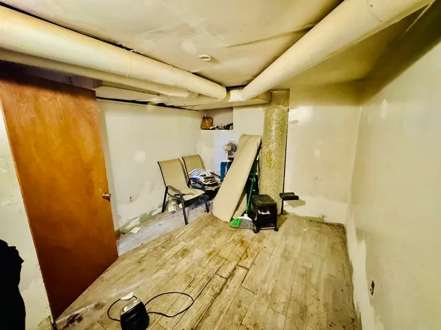 a view of a room with wooden floor and windows