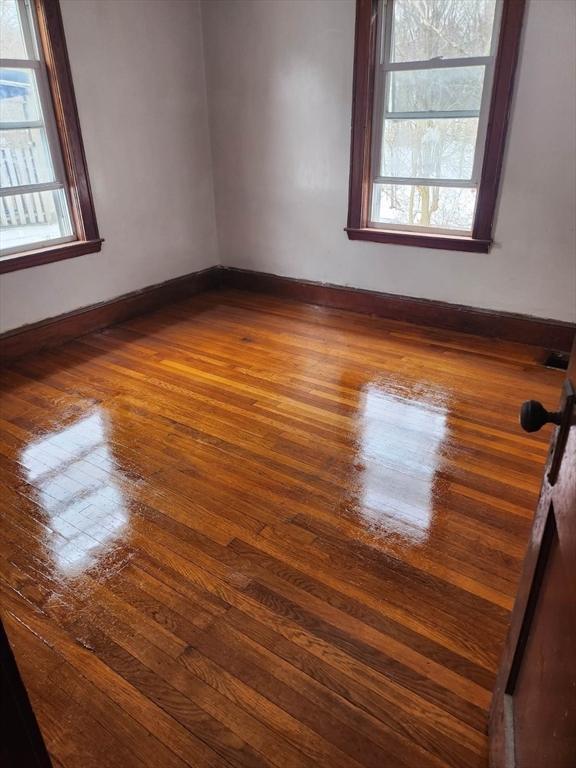 75-77 Belnel Road Boston, MA 02136 - Photo 7 of 23 an empty room with wooden floor and windows