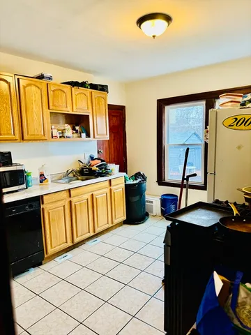 a kitchen with a sink and a stove top oven