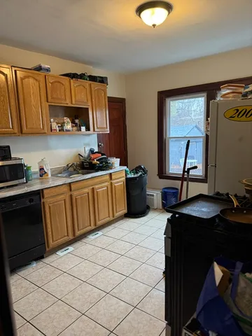 a kitchen with a sink appliances and cabinets