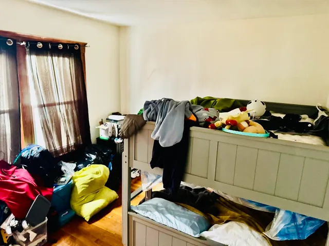 a bedroom with a bed and dresser