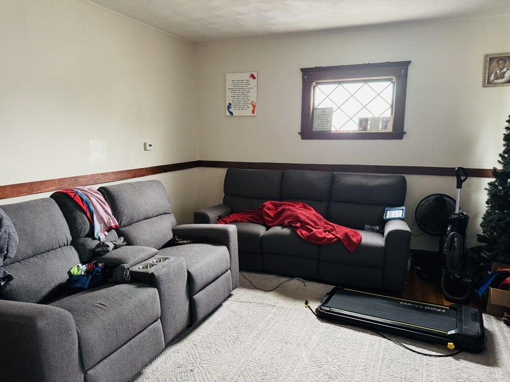 75-77 Belnel Road Boston, MA 02136 - Photo 10 of 23 a living room with furniture a couch and a window