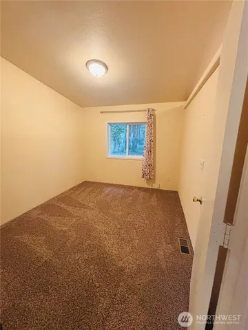 a large kitchen with a table and chairs
