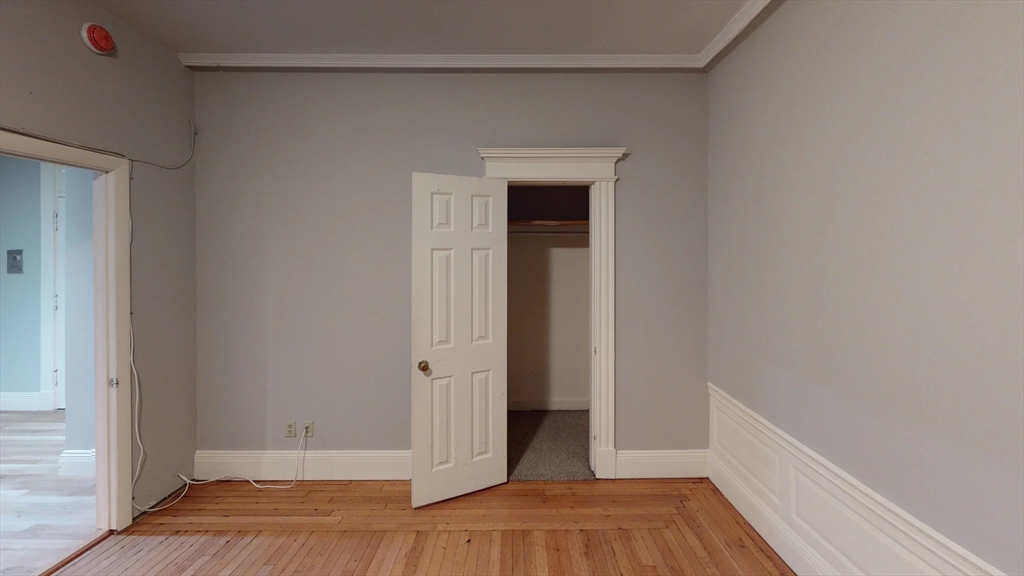 466 Commonwealth Avenue, Unit 406 Boston, MA 02215 - Photo 4 of 8 a view of a hallway with wooden floor