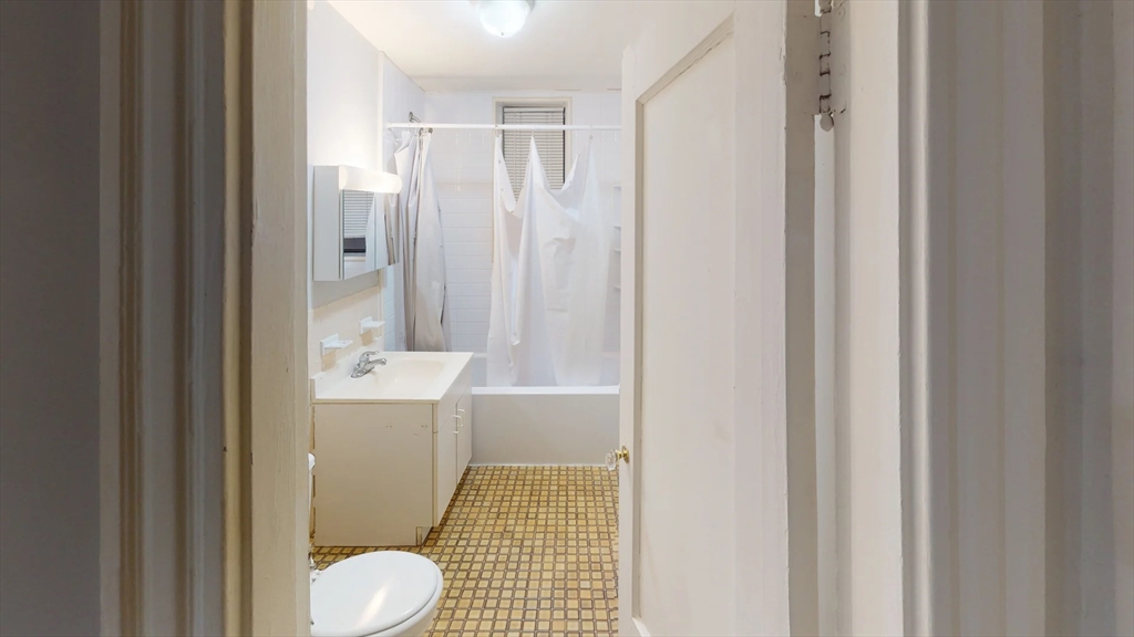 466 Commonwealth Avenue, Unit 406 Boston, MA 02215 - Photo 7 of 8 a bathroom with a sink toilet and shower