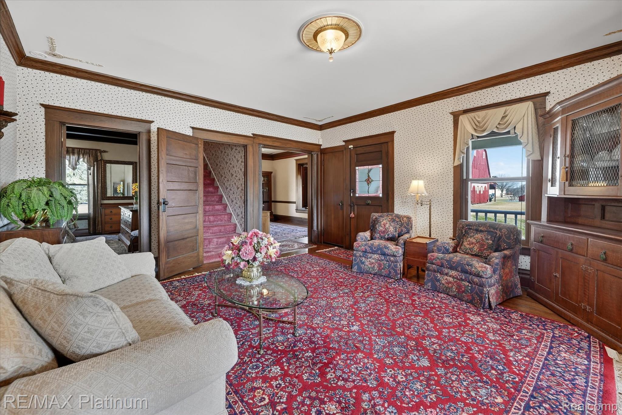 15330 Howlett Road Gregory, MI 48137 - Photo 9 of 26 Living room featuring ornamental molding, wallpapered walls, plenty of natural light, and wood finished floors