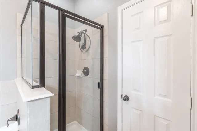 a bathroom with a bath tub sink mirror vanity and toilet