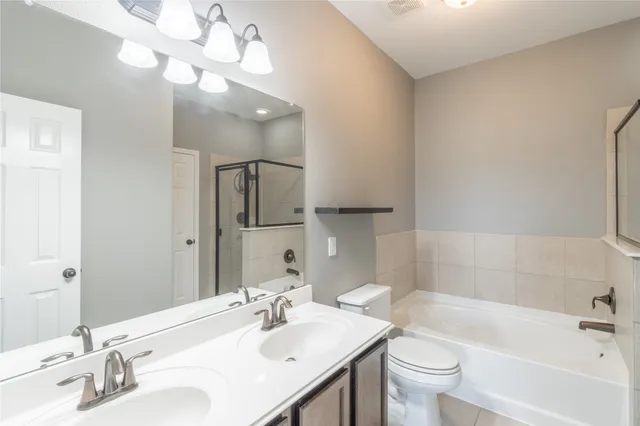 a view of a big room with wooden floor and a ceiling fan