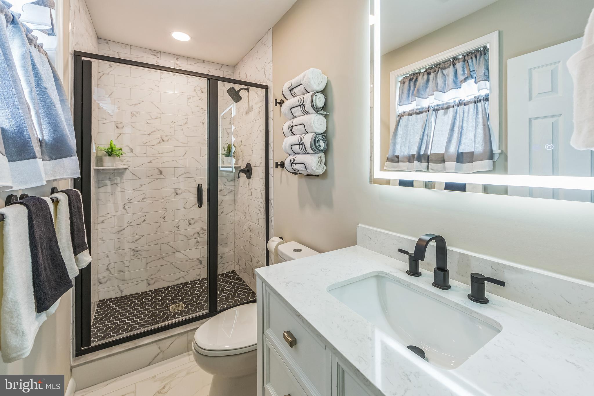44 South Brookside Road Springfield, PA 19064 - Photo 21 of 30 a bathroom with a sink toilet and shower