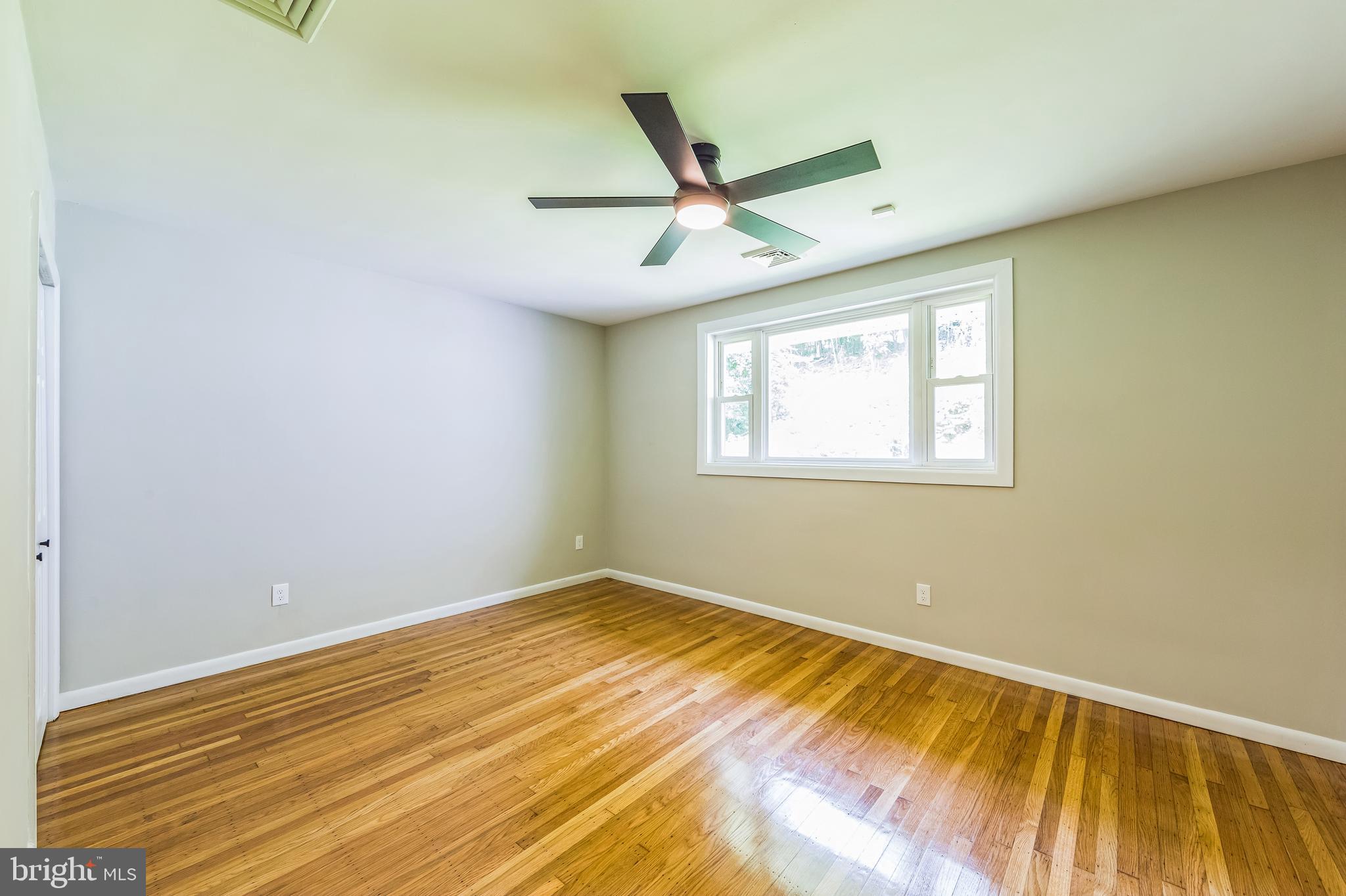 44 South Brookside Road Springfield, PA 19064 - Photo 22 of 30 a view of a room with wooden floor and a ceiling fan