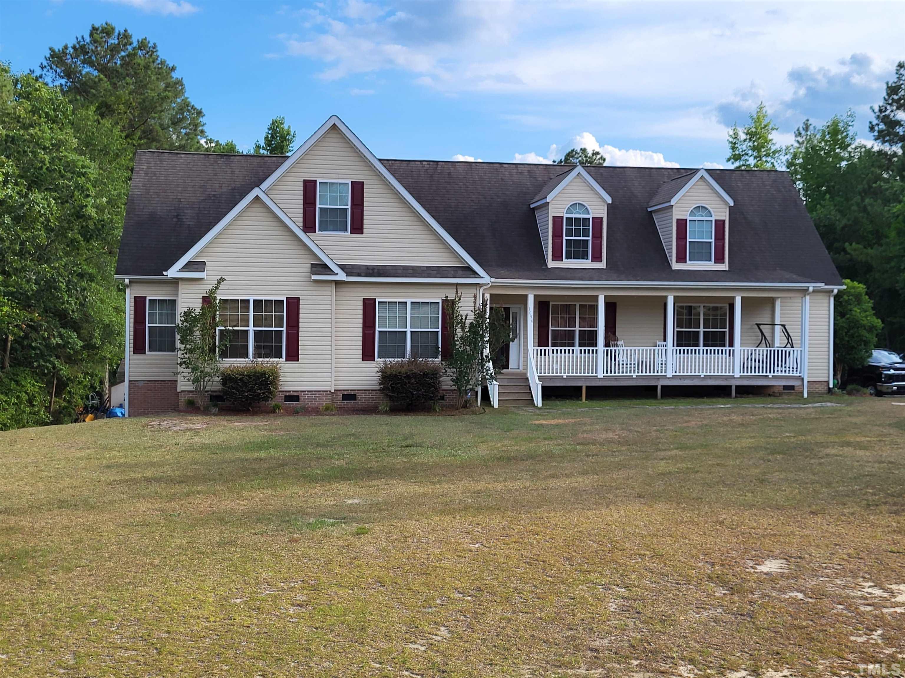 1096 Fire Lane Road Bunnlevel, NC 28323 - Photo 1 of 37 a view of a large house with a large windows and large trees