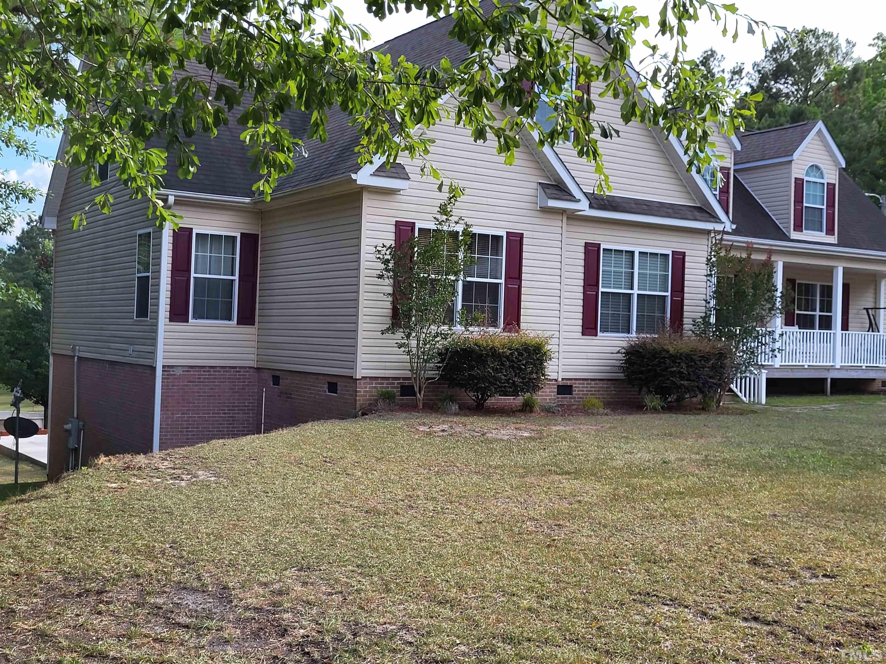 1096 Fire Lane Road Bunnlevel, NC 28323 - Photo 2 of 37 a front view of a house with garden