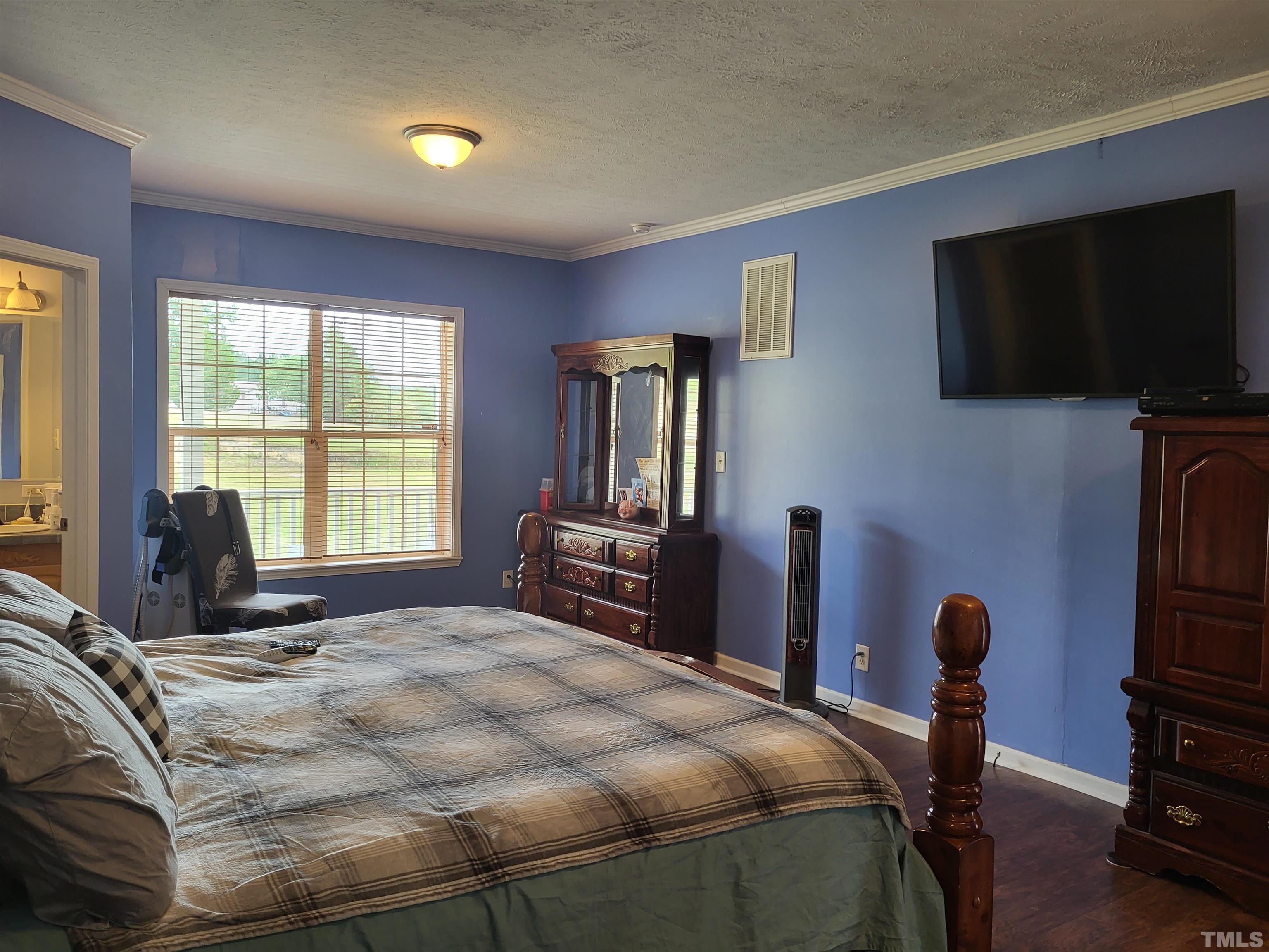 1096 Fire Lane Road Bunnlevel, NC 28323 - Photo 9 of 37 a bedroom with a bed and a television