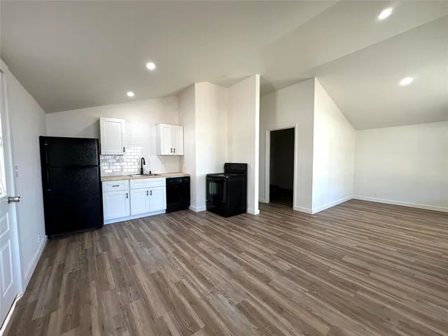 a kitchen with a refrigerator and a sink