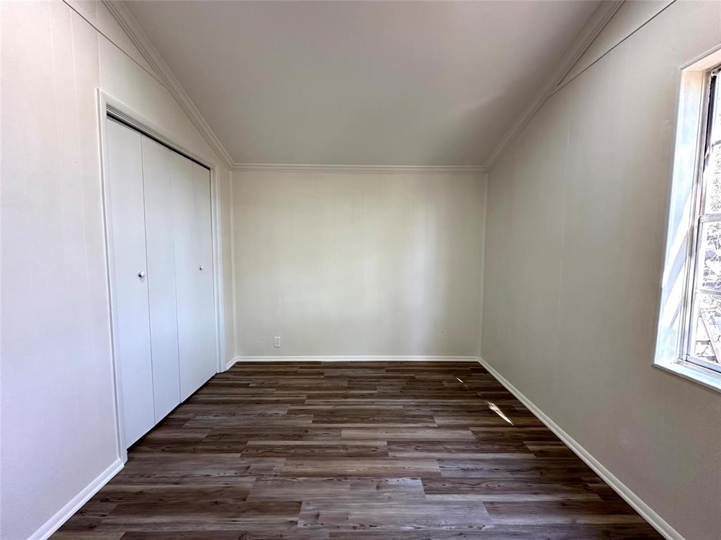 102 North Pinto Street Comanche, TX 76442 - Photo 4 of 23 a view of empty room with wooden floor and fan
