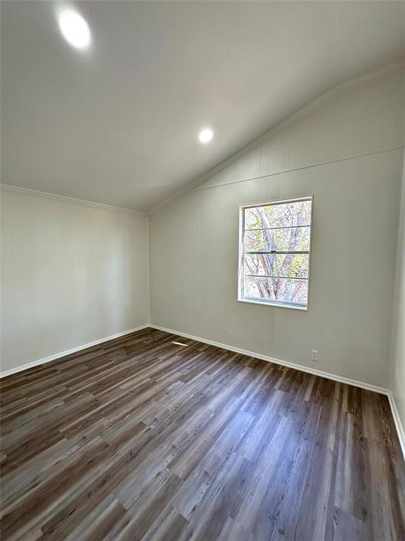 102 North Pinto Street Comanche, TX 76442 - Photo 8 of 23 an empty room with wooden floor and windows