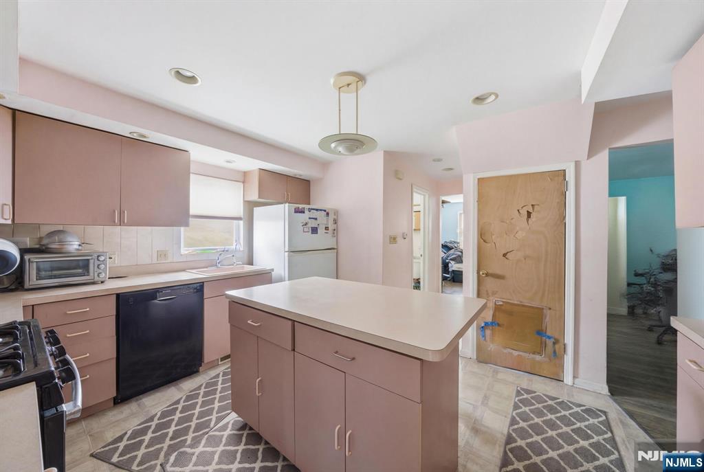 106 Summit Avenue Bloomfield, NJ 07003 - Photo 2 of 18 a kitchen with a sink stove and refrigerator