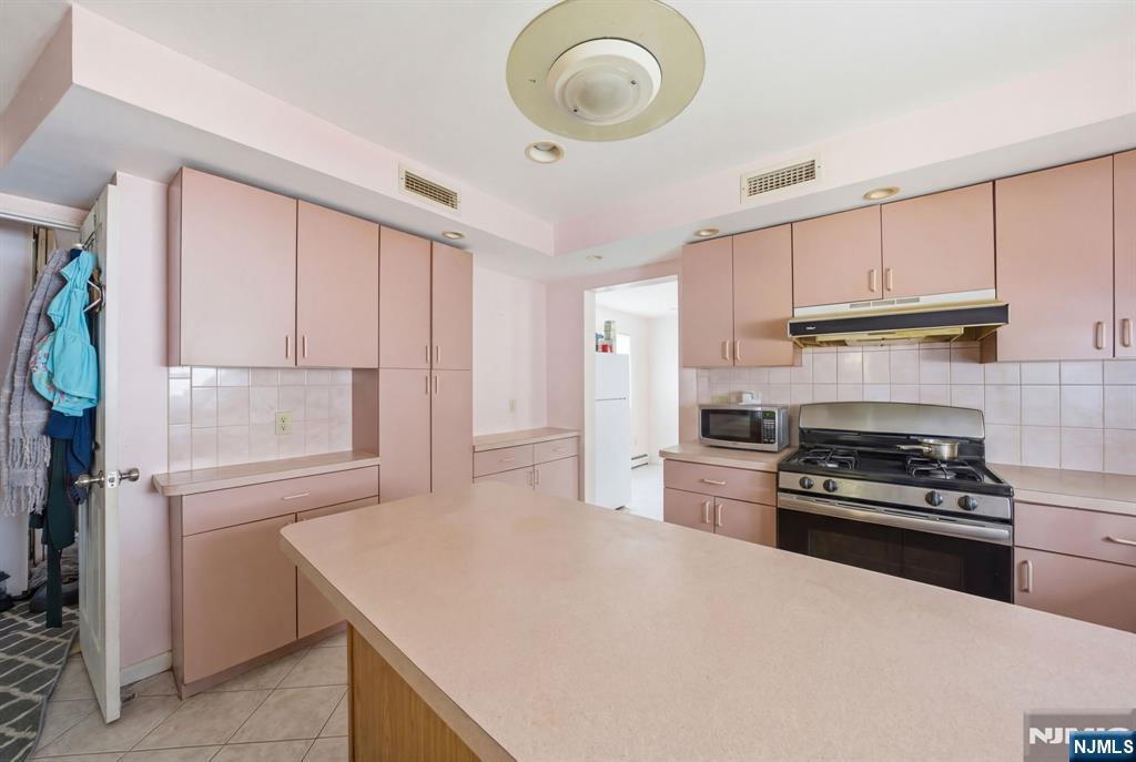 106 Summit Avenue Bloomfield, NJ 07003 - Photo 3 of 18 a kitchen with kitchen island granite countertop a stove a sink and a refrigerator