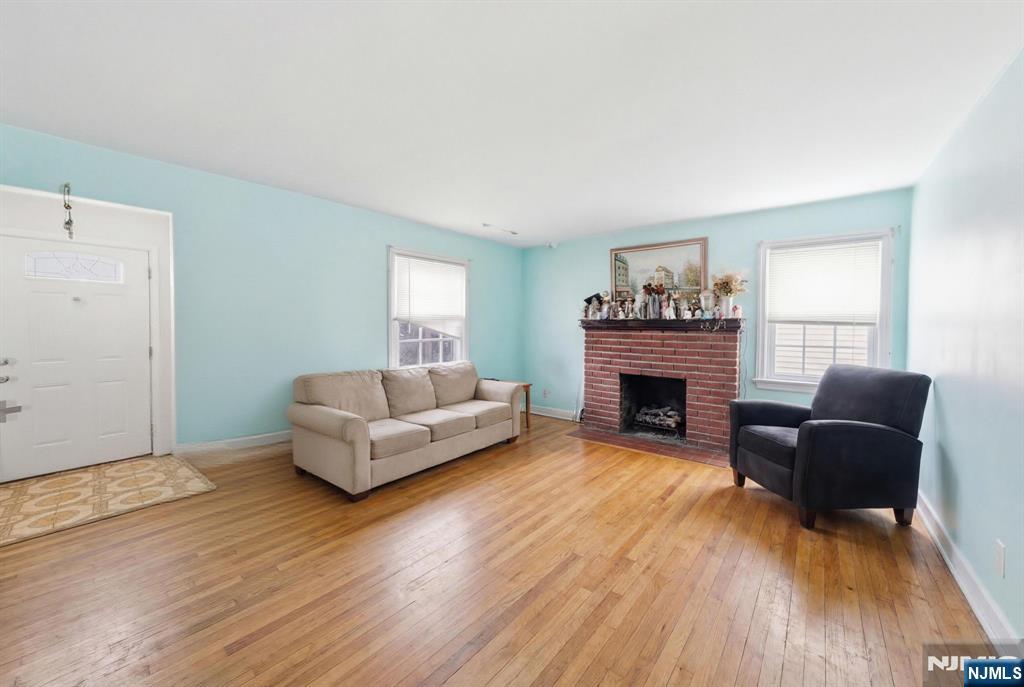 106 Summit Avenue Bloomfield, NJ 07003 - Photo 5 of 18 a living room with furniture and a fireplace